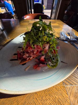 Bruschetta (vegan), mostly a pile of chopped tomatoes and onions with a tiny piece of bread. at Garvie & Co in Milngavie