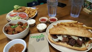 Santa Fe chicken sandwich, Beyond cheesesteak & cauliflower with sweet & sour orange dipping sauce at Veggie Grill by Next Level - River North in Chicago