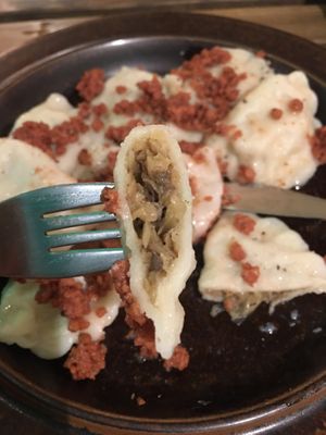 Mushroom and cabbage pierogies topped with vegan bacon  at no bones in Krakow