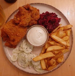 Breaded oyster mushrooms, fries, cucumber and beetroot salads, and garlic sauce at no bones in Krakow