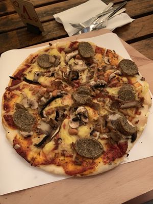 Four mushrooms pizza with added vegan sausage at no bones in Krakow