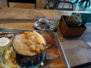 Porridge with mango, banana, coconut and agave syrup as toppings. at Kahuna Poke Bros in Frankfurt