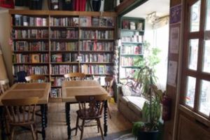 Seating area in front with the bookshop - numerous radical titles including a WHOLE SECTION on veganism / animal rights! at The Cowley Club in Brighton
