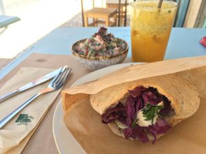 Falafel pitta in the front, "Middle Eastern" salad and orange juice in the back at Yallah in Lisbon