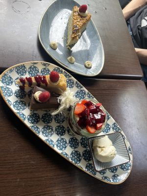 The dessert platter in the front and a piece of snickers cake in the backk  at Kuli Alma in Frankfurt