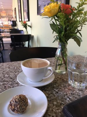Vegan orange raw ball and coffee with oatmilk at Chokladfabriken in Stockholm