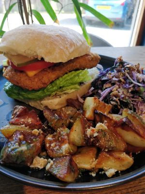 Homemade chicken-style burger with crispy potatoes and coleslaw  at Satellite Cafe in Falmouth