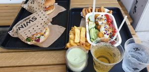 Schnitzel burger, cheese burger, nugget salad, chips, onion rings - yum!!  at Swing Kitchen - Schwedenplatz in Vienna