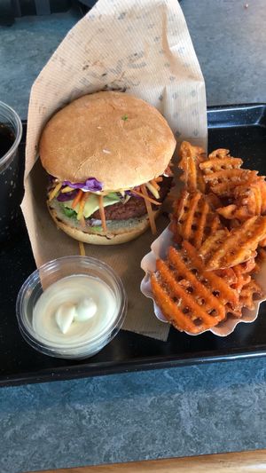 Vegan burger and sweet potato waffle fries at Swing Kitchen - Schwedenplatz in Vienna
