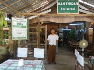 restaurant interior decor,  trip advisor excellent award and the boss's son at San Thi Dar Restaurant in Bagan