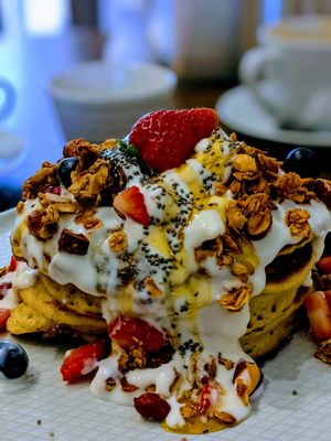 Stacked granola and berry pancakes 🤤 at The Carrot's Tail in Rathmines