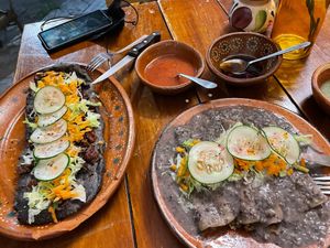 Huarache azteca -guisos chicharrones and papamaica (bottom). Enfrijoladas with asada (top) at La Vegana Garnacha in Guadalajara