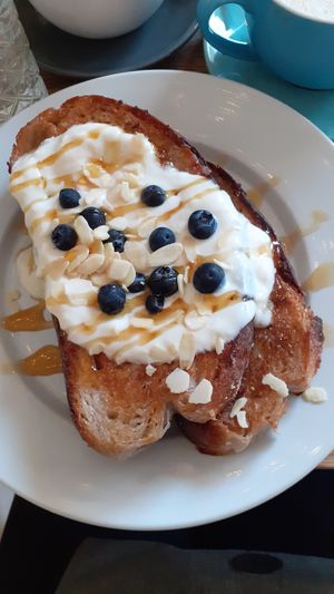French toast with yoghurt, blueberries, almonds and maple syrup. at Chapter One Coffee Shop in Edinburgh