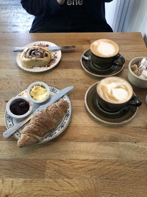 Cappuccino, latte, cinnamon roll, and croissant at Chapter One Coffee Shop in Edinburgh