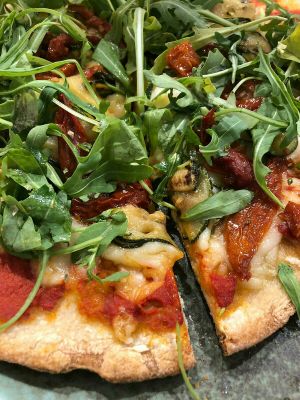 Sourdough pizza with tomate sauce, AMAZING vegan mozzarella, zucchini, dehydrated tomatoes, fresh basil and arugula at Odacova in Barcelona