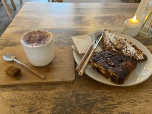 Pumpkin spice latte (allright), almond croissant (very good) and cinnamon roll (very good)  at Plenty in The Hague
