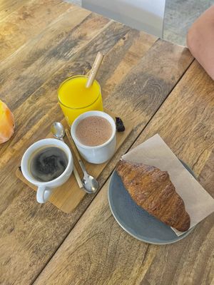 Black coffee, hot chocolate, fresh orange juice and a croissant  at Plenty in The Hague