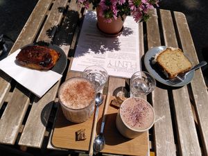 From left: cinnamon roll, chai latte, choco latte, and lemon coconut cake at Plenty in The Hague