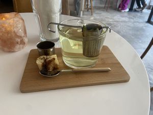 Herbal tea verbena (huge glass and good) and a small piece of cinnamon roll (great)   at Plenty in The Hague