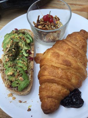 Breakfast platter: croissant, granola, avo toast, choice of jam/butter/ or both!  at Plenty in The Hague