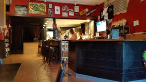 View near the restaurant entrance of order counter, kitchen, and back venue entrance. at Mark of the Beastro in Salt Lake City