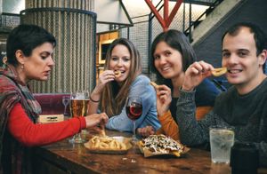 Trying the delicious tapas we test during the tour at Madrid Vegan Tours in Madrid