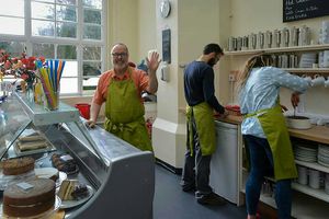 The happy staff and cakes at Manjushri in Ulverston