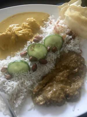 Yellow lime and rendang curries with coconut rice - via Deliveroo  at Kuala Lumpur Café in Leeds