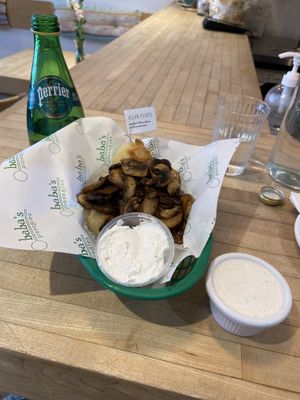 Pan fried vegan potato pierogis topped with sautéed mushrooms and a side of vegan horseradish dip. The meal of my dreams!  at Baba's Pierogies in Brooklyn