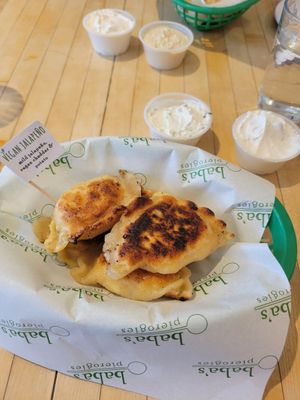Vegan jalapeno pierogies with vegan sour cream and sour cream and chive dip at Baba's Pierogies in Brooklyn