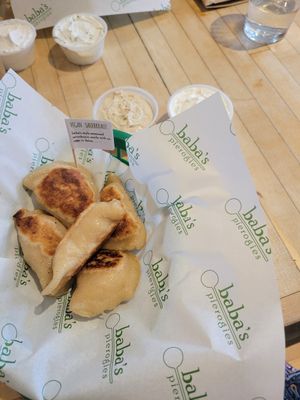 Vegan sauerkraut pierogies with vegan onion dip and sour cream at Baba's Pierogies in Brooklyn