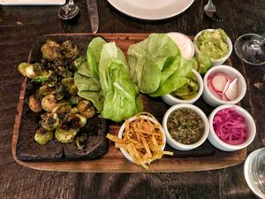 A cross between tacos and Asian lettuce cups, where you rolled your roasted brussel sprouts with your choice of toppings.  The creamy one and the pickled onions were divine. at Dirt Candy in New York City