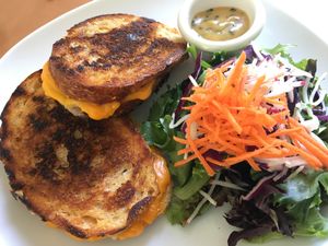 Grilled three cheese melt with spicy aioli . The side salad is served with Plantitude’s miso dressing. at Plantitude in Ladysmith