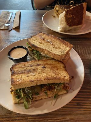 Brunch sandwich on GF bread, Philly burrito in background  at High Note Cafe in Boise