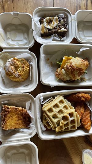Top left to bottom right: hash brown wedge, honee butter biscuit, wings and waffles, crossaint-wich, s’mores brownie at Verdine in Houston