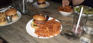 All 3 burgers/sandwiches and the Caesar salad. Burger in front is the beyond. Highly recommend trying this one, the cheddar is amazing. at Verdine in Houston