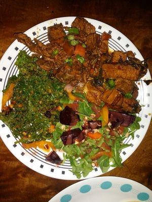 plate with jamaican jerk, kale salad, arugula beet salad and spicy basil tofu at Good Karma Artisan Ales & Cafe in San Jose