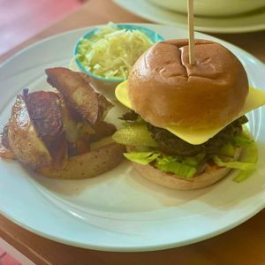 Homemade mixed mushroom and seitan burger with double cooked skin on potato wedges and Romanian cabbage salad at Catchacarrot Vegan in Ardfern