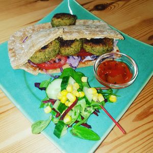 Thai style bites in a pitta with red cabbage , tomatoes and mango chutney . at Catchacarrot Vegan in Ardfern