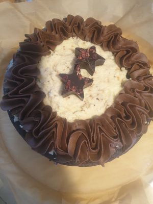 A cheeky coconut and chocolate birthday cake made always with organic flour at Catchacarrot Vegan in Ardfern
