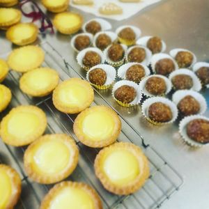 Homemade lemon curd tarts . In the background homemade date and walnut balls .  at Catchacarrot Vegan in Ardfern