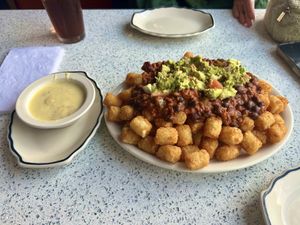 Impossible tots—this was supposed to be an appetizer, but is a MASSIVE mountain of tots, Impossible chili, guac, and cheese  at The Lindenhurst Diner in Lindenhurst