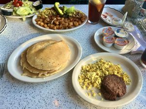 Large stack of pancakes with a side of sausage and very eggy tofu scramble  at The Lindenhurst Diner in Lindenhurst