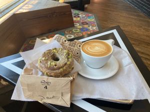 Pistachio vegan sourdough donut and vegan cappuccino.  at Doughnut Plant - Flatbush in Brooklyn