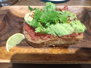 Tostada de aguacate con lima, cilantro y almendra. at Eqvilibrivm Cafe in Barcelona