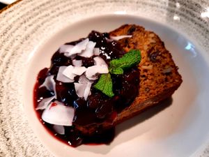 Plum cake with berry sauce at Eqvilibrivm Cafe in Barcelona