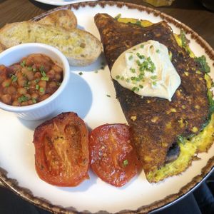 Omelette with mushrooms, kale and a dollop of cream cheese .  at Eqvilibrivm Cafe in Barcelona