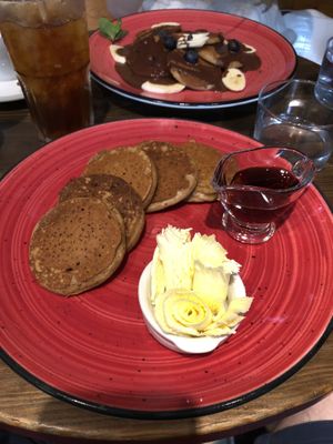 Vegan pancakes, banana and chocolate or maple syrup  at Eqvilibrivm Cafe in Barcelona