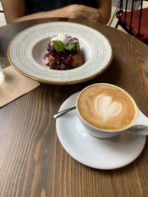 Vegan Carrot Cake with Berry Compote and a Flat White  at Eqvilibrivm Cafe in Barcelona