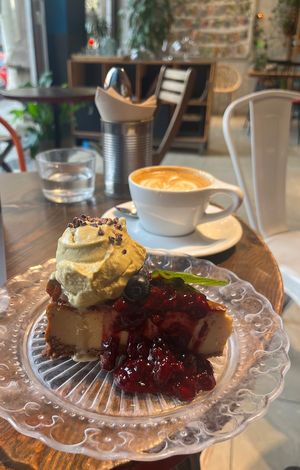 Cheese Cake with berries & pistachio ice cream  at Eqvilibrivm Cafe in Barcelona